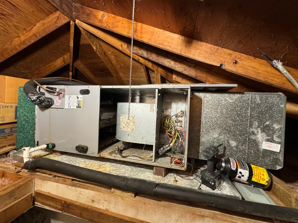 Interior view of an HVAC blower motor and electrical wiring during a repair.